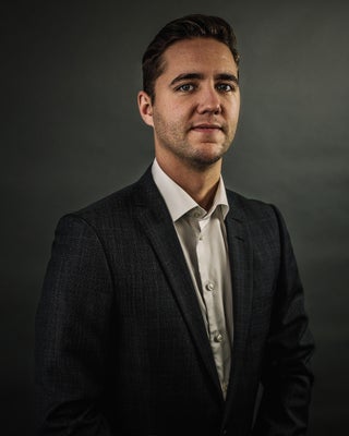 Portrait of Josh Currie, Associate.